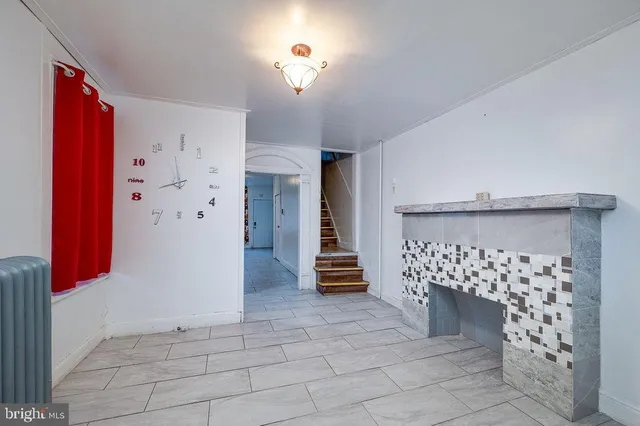 a view of a hallway with entryway and stairs