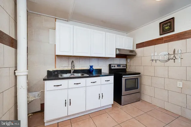 a kitchen with stainless steel appliances granite countertop a refrigerator and a stove