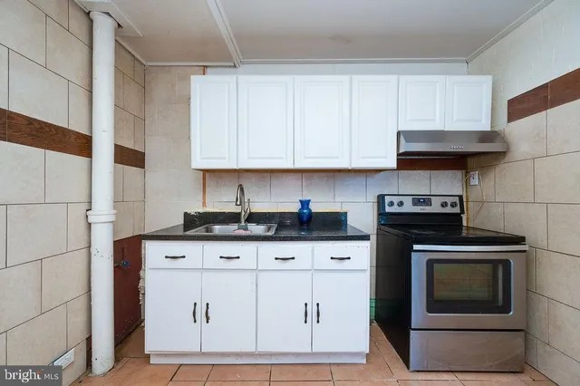 a metallic refrigerator freezer sitting in a kitchen