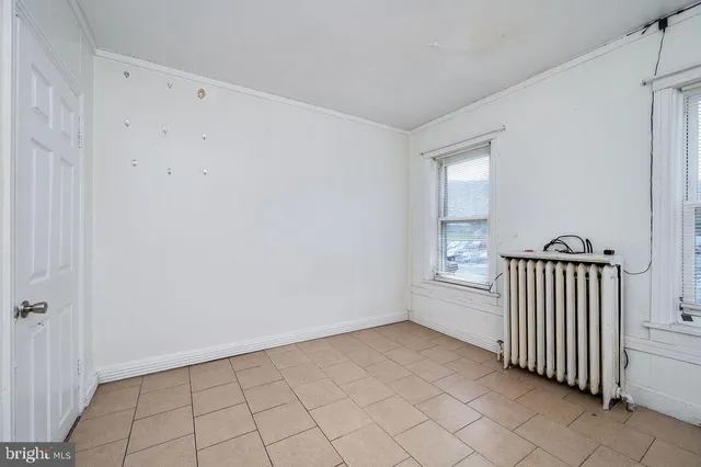 a view of a room with white walls and stairs