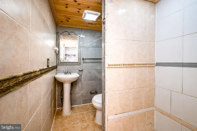 a view of a livingroom with wooden floor and a flat screen tv