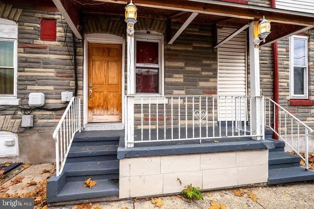 a view of front door of house with stairs