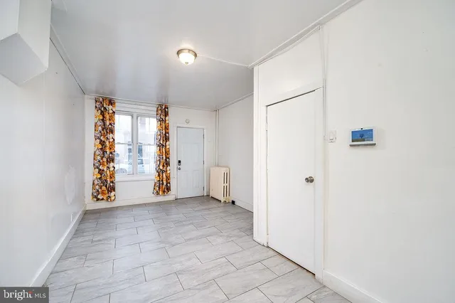 a view of a hallway with wooden shelves