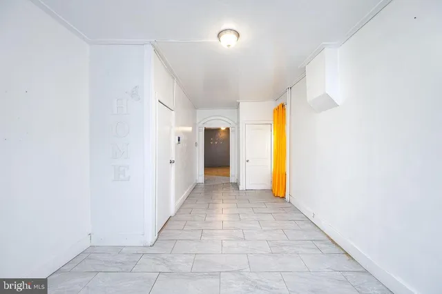 a view of a hallway with wooden shelves