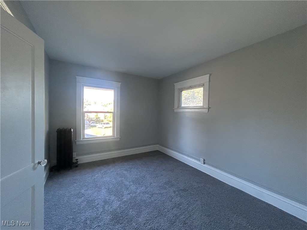 1229 Melbourne Road Cleveland, OH 44112 - Photo 21 of 22 Carpeted empty room featuring baseboards and radiator heating unit