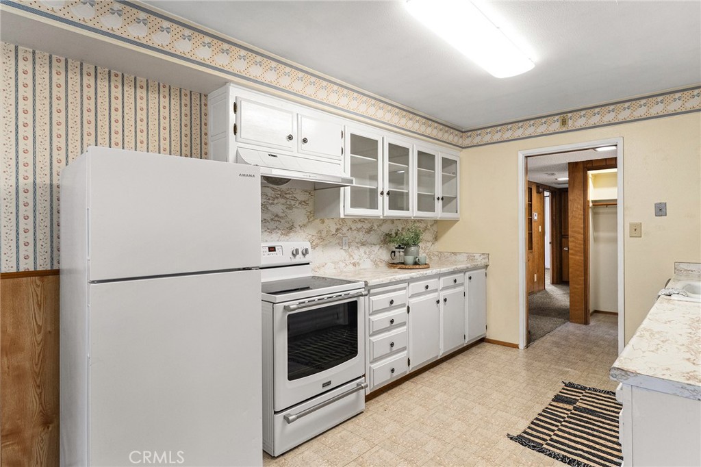 6682 Brook Way Paradise, CA 95969 - Photo 6 of 56 a kitchen with stainless steel appliances a refrigerator sink and cabinets