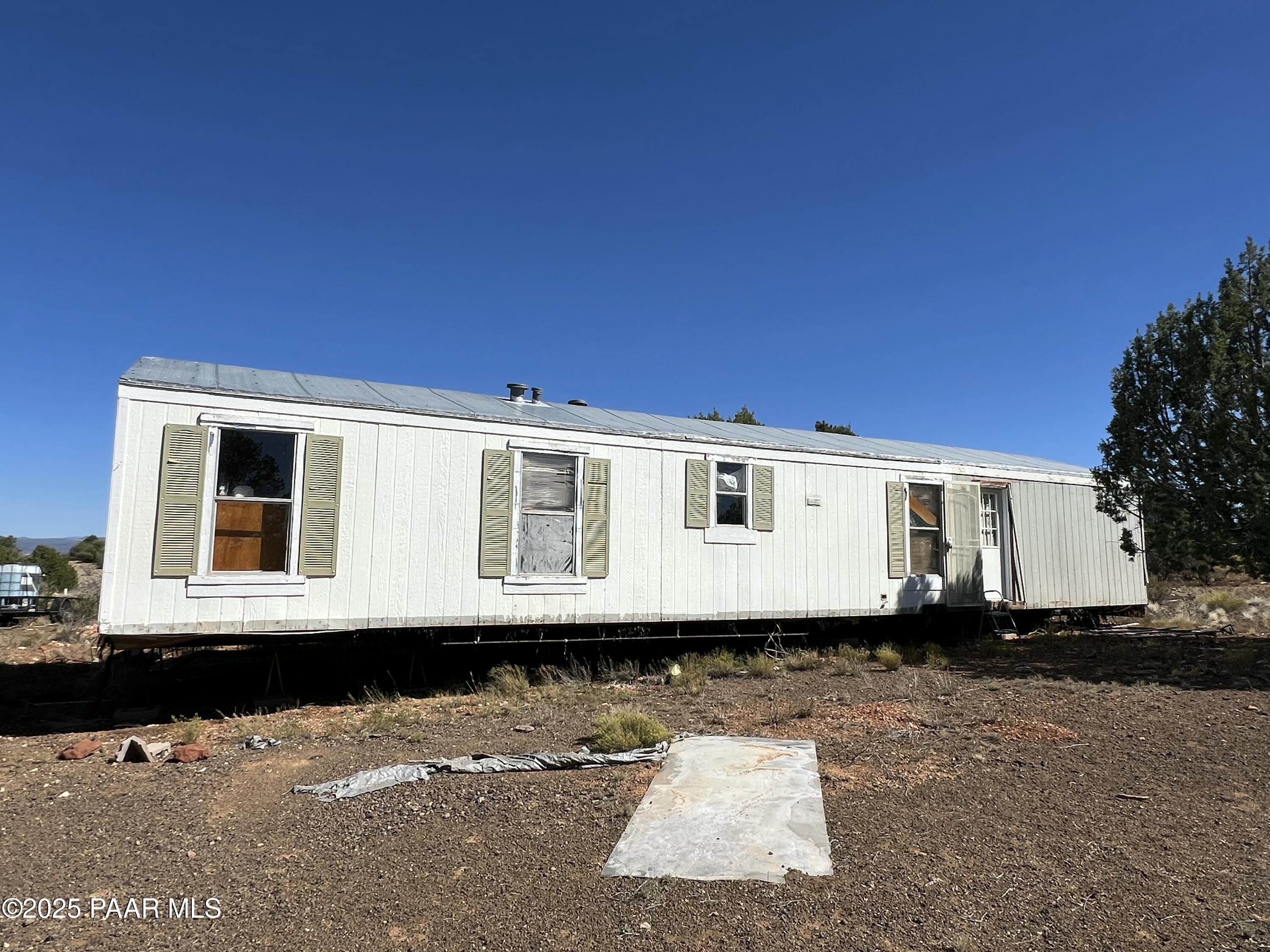 9 B Off Ranch Road Ash Fork, AZ 86320 - Photo 4 of 10 a front view of a house with a yard