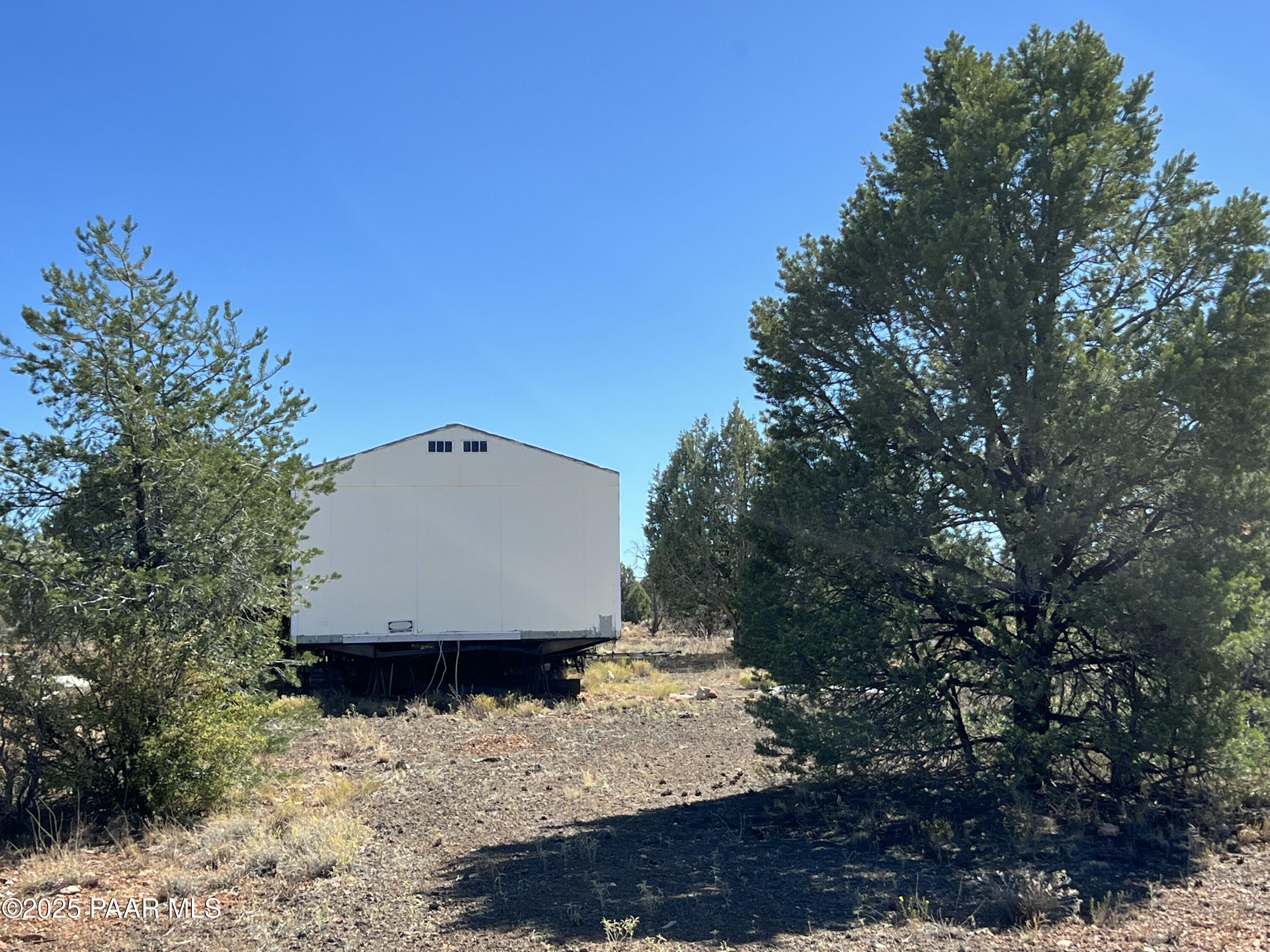 9 B Off Ranch Road Ash Fork, AZ 86320 - Photo 5 of 10 a view of a white house in middle of the forest