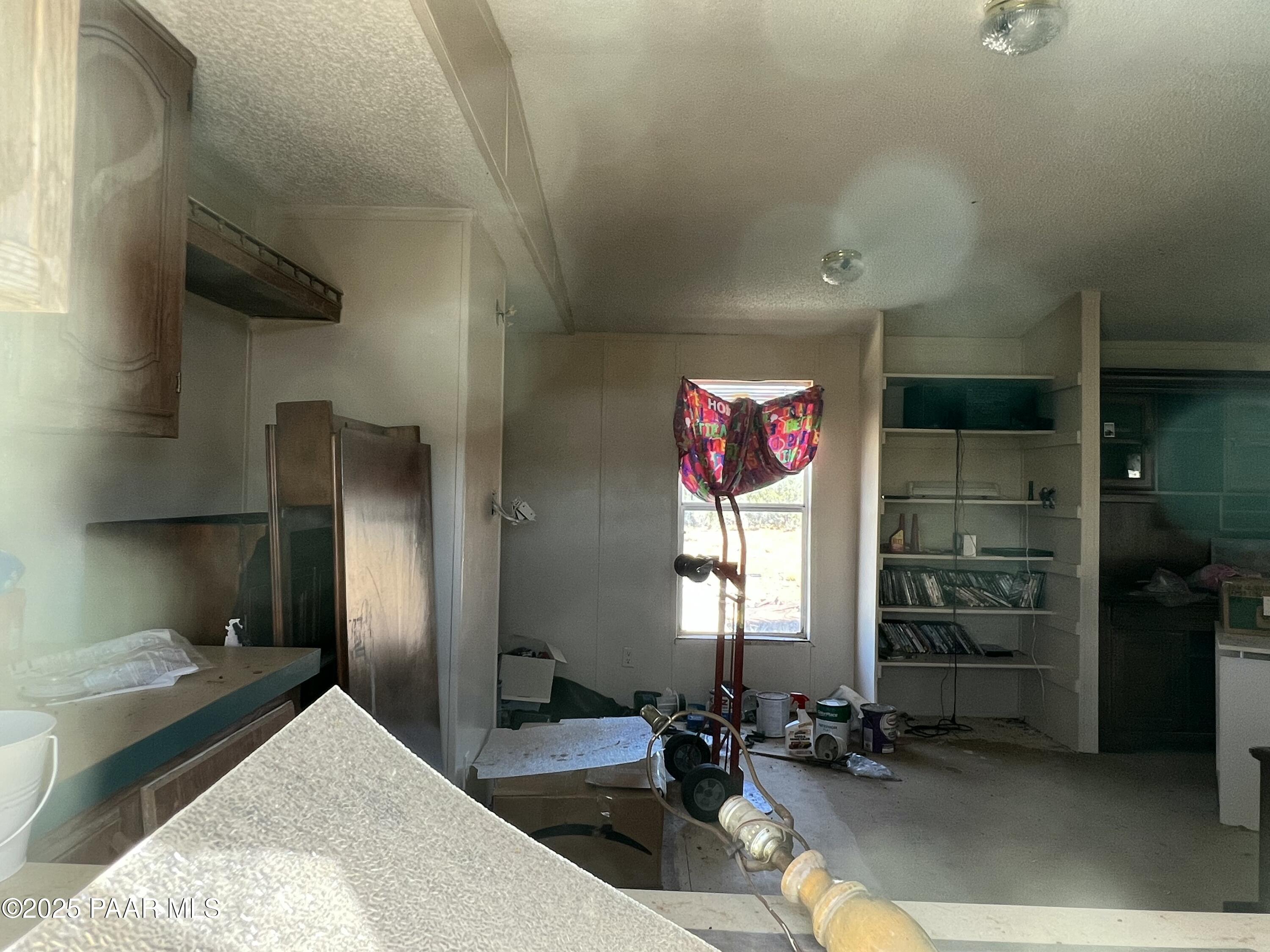 9 B Off Ranch Road Ash Fork, AZ 86320 - Photo 10 of 10 a very nice looking room with a large window and chandelier