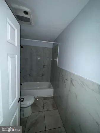 a bathroom with a shower and toilet