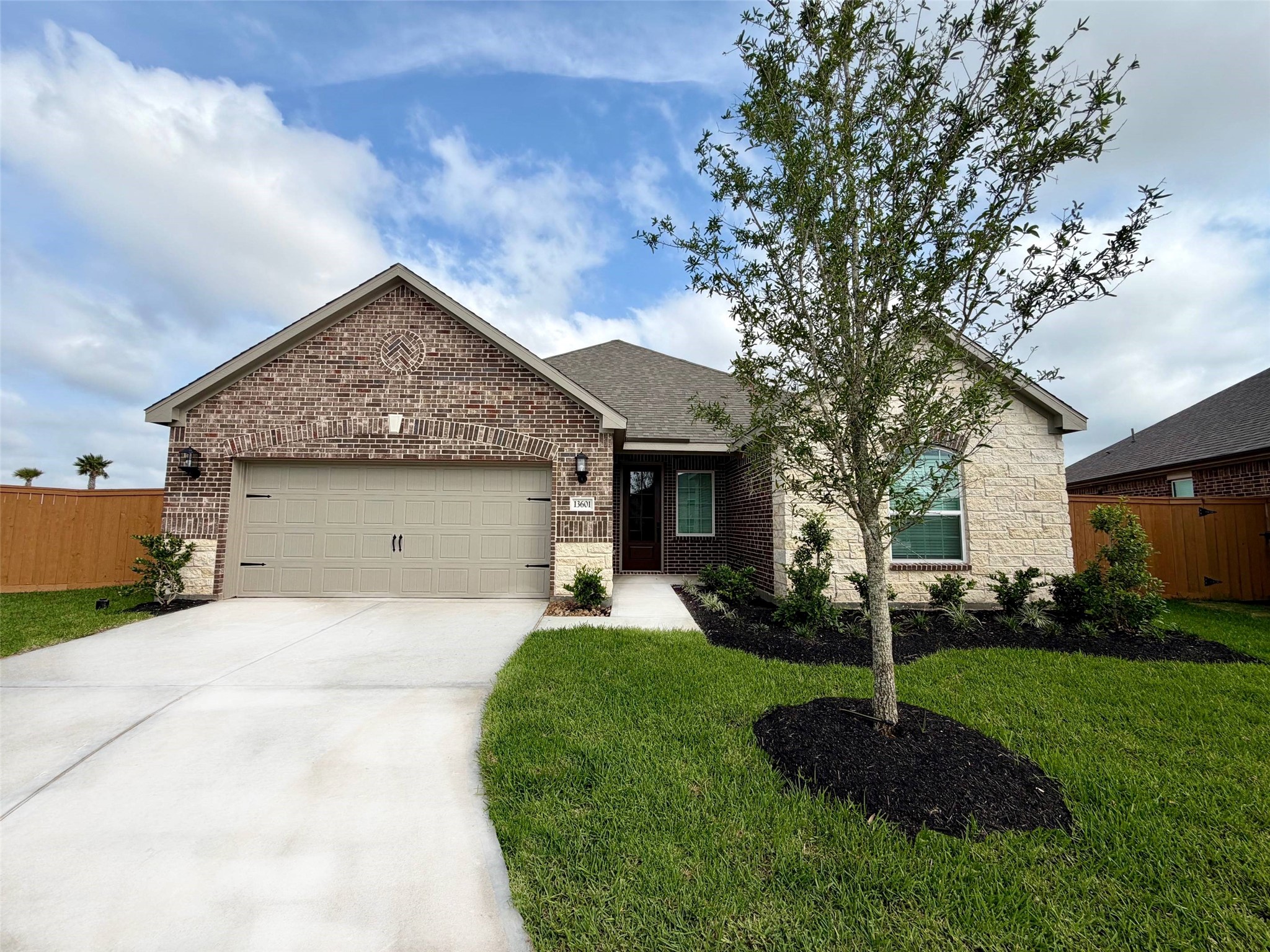 13601 Gaff Rig Drive Texas City, TX 77510 - Photo 1 of 20 a front view of a house with a garden and trees