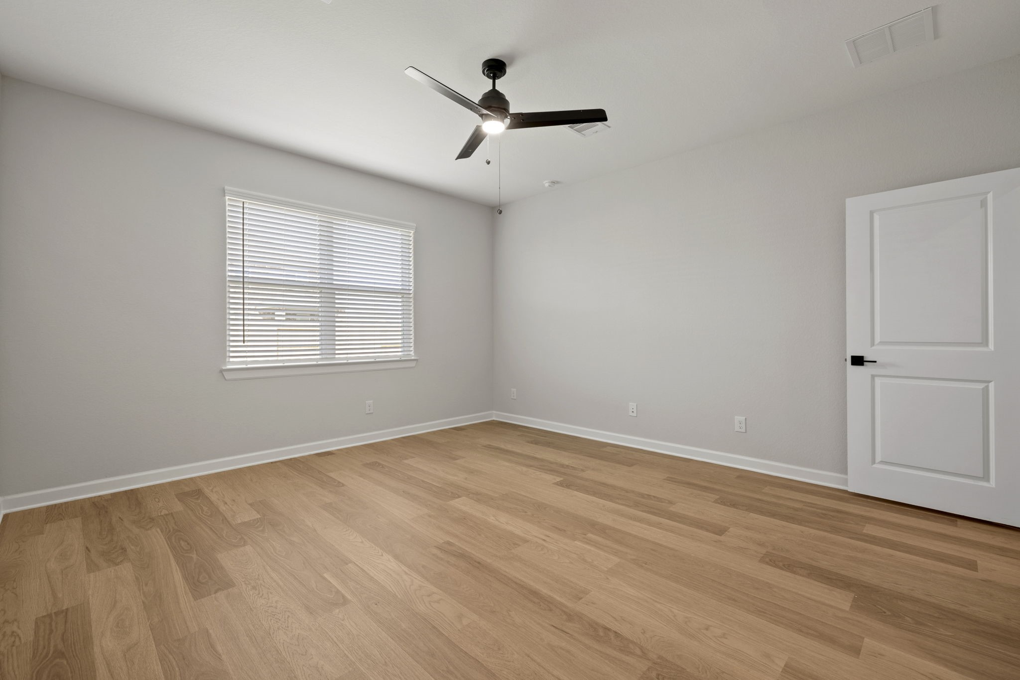 13601 Gaff Rig Drive Texas City, TX 77510 - Photo 11 of 20 an empty room with wooden floor ceiling fan and windows