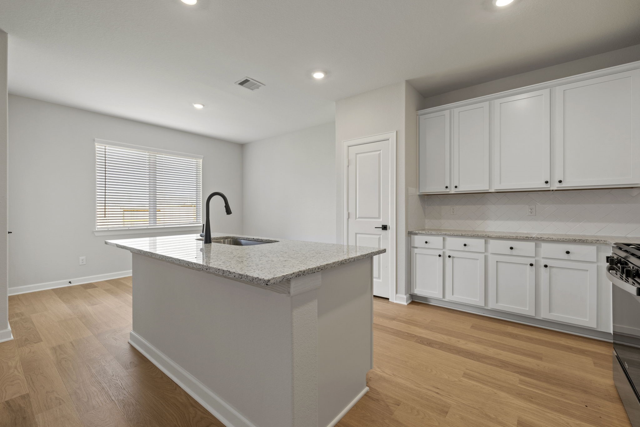 13601 Gaff Rig Drive Texas City, TX 77510 - Photo 6 of 20 a kitchen with stainless steel appliances granite countertop a sink a stove and a wooden floors