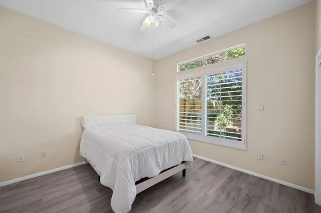 a bed sitting in a bedroom next to a window