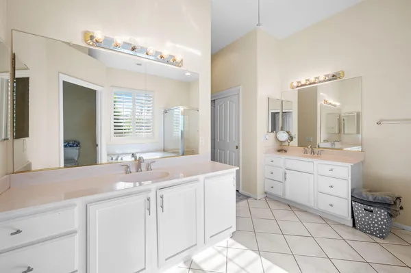 a bathroom with a sink double vanity and a mirror