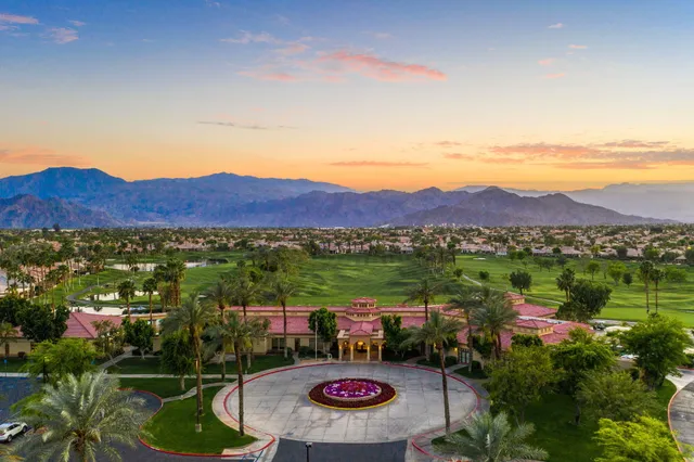 a view of a lush green hillside and houses