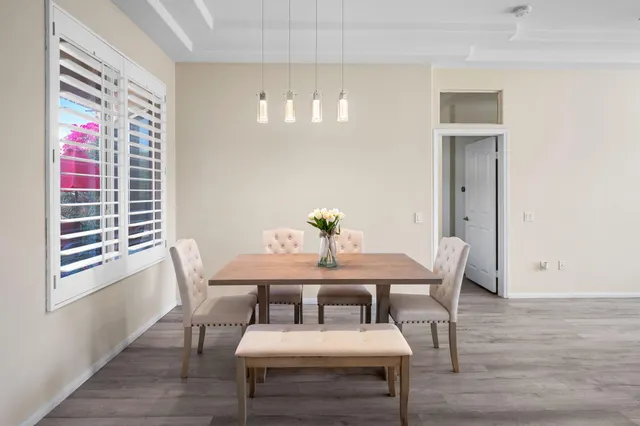 a view of a dining room with furniture and wooden floor