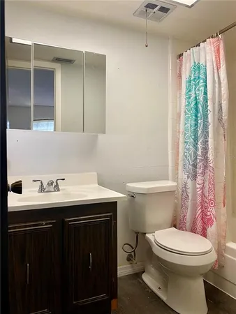 a bathroom with a sink toilet and a mirror