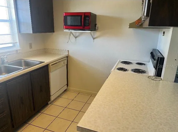 a kitchen with a sink a stove and cabinets