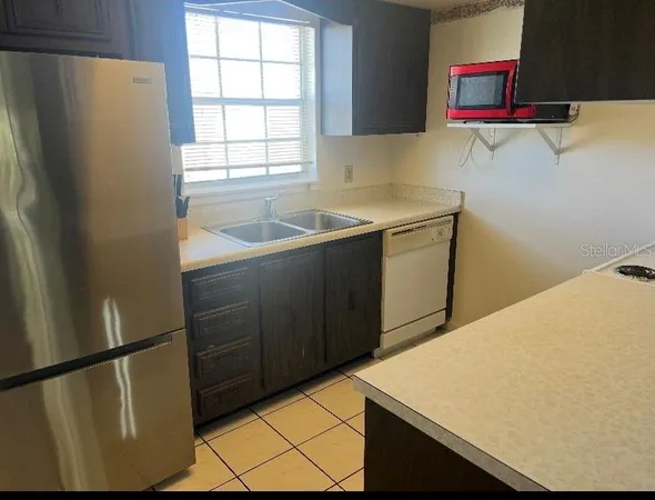 a kitchen with a refrigerator and a sink
