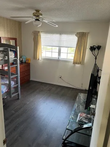 a room with wooden floors and window