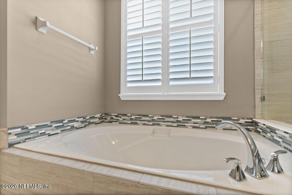 841 Ifield Road St. Augustine, FL 32095 - Photo 29 of 69 a bathroom with a bathtub and a window