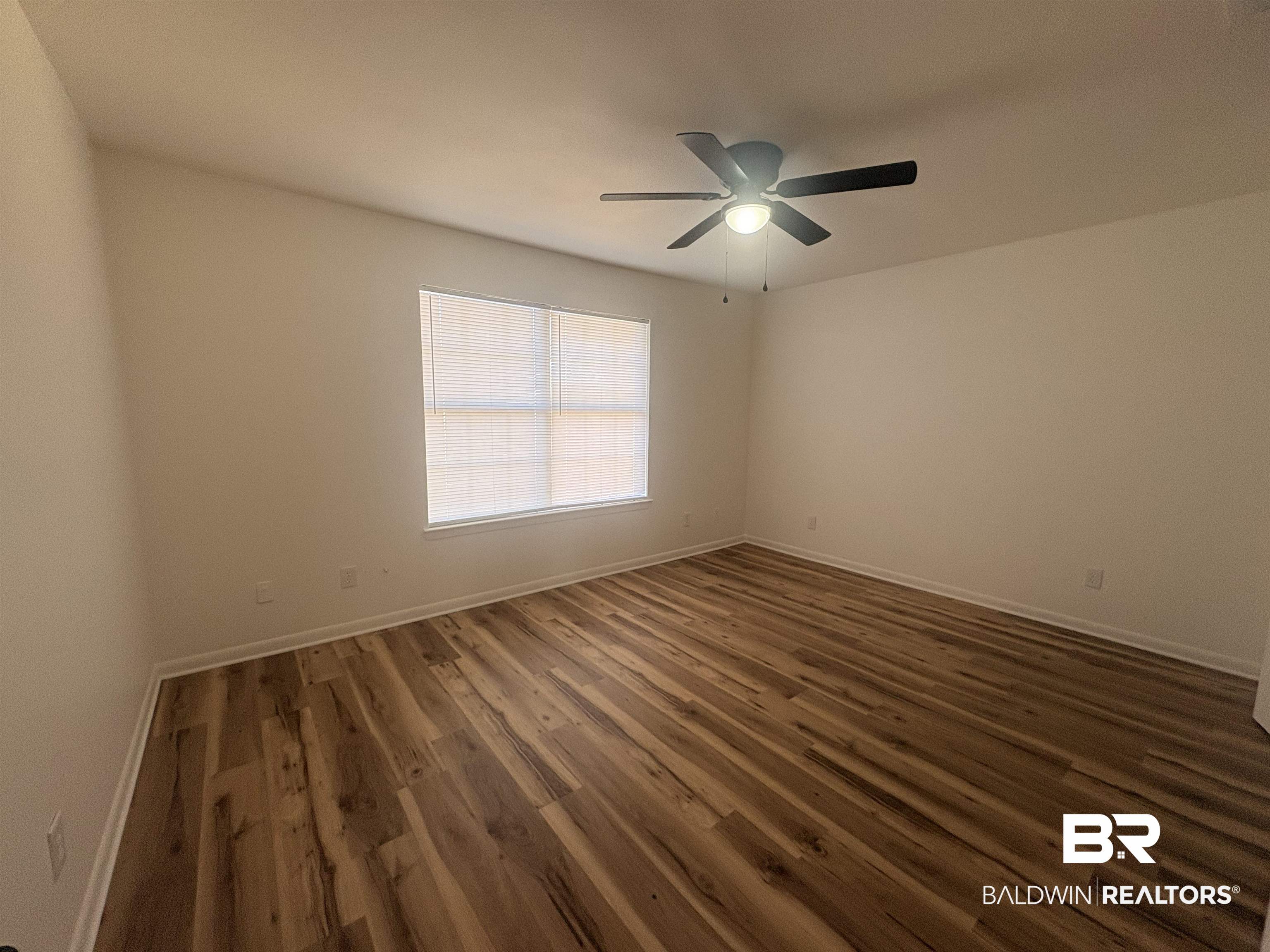 109-111 North Beech Street, Unit A & B Foley, AL 36535 - Photo 7 of 16 Spare room featuring dark wood finished floors and ceiling fan