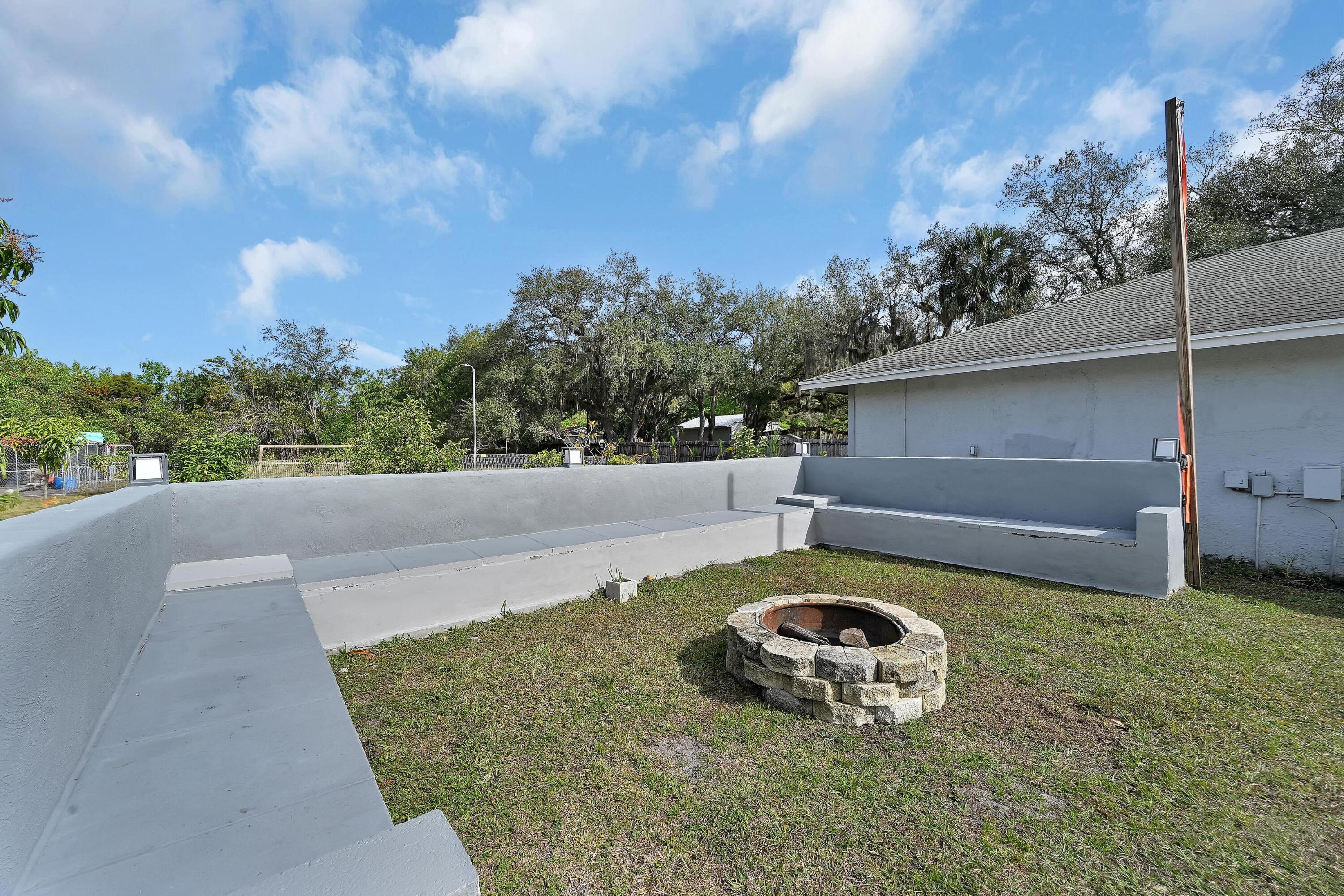2404 Dade Road Fort Pierce, FL 34982 - Photo 54 of 61 BENCH AREA & FIRE PIT
