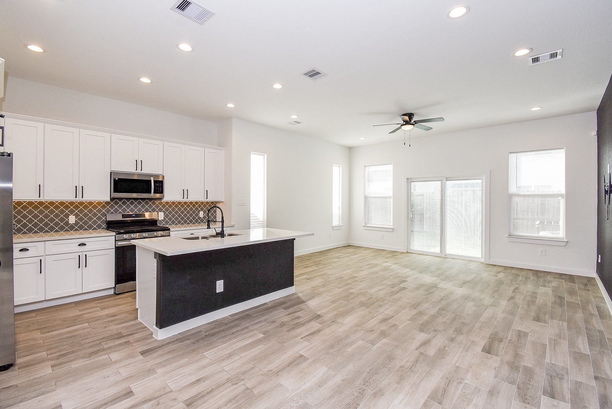 6828 Liverpool Street Houston, TX 77021 - Photo 6 of 32 a kitchen with stainless steel appliances granite countertop a stove and a sink