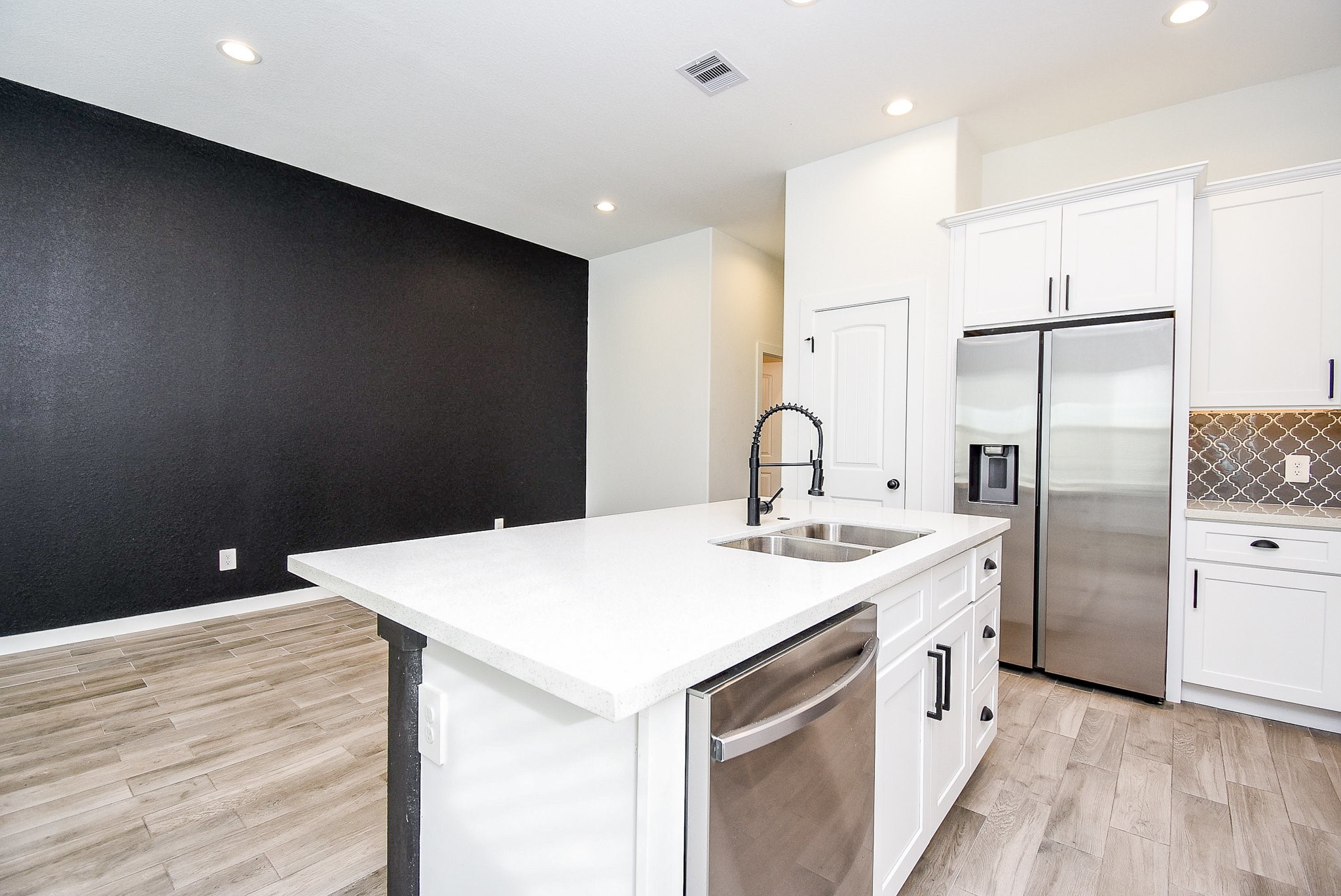 6828 Liverpool Street Houston, TX 77021 - Photo 10 of 32 a kitchen with a sink a refrigerator and cabinets