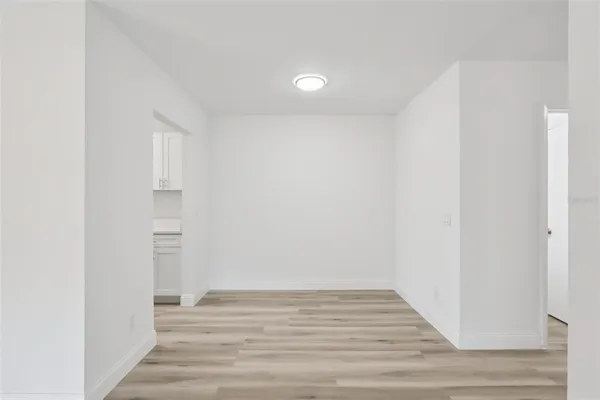 a view of room with wooden floor