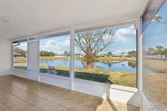 a view of living room with a large window and pool table