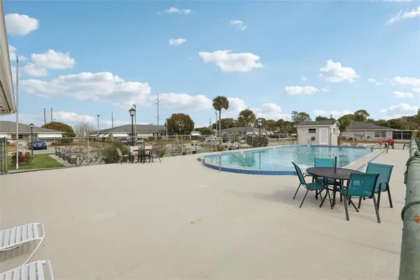 a view of a patio with a table and chairs