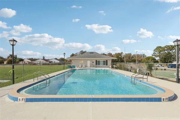 a view of a swimming pool with a yard