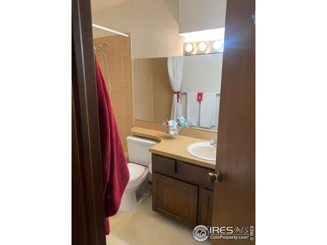 a view of a room with a large mirror and furniture