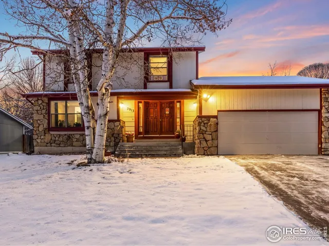 a view of a house with a large tree