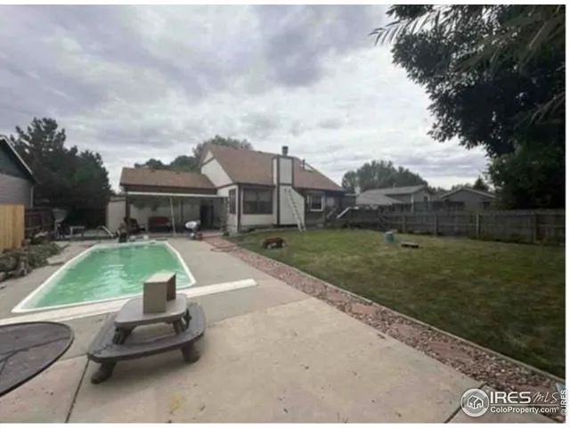 a view of a backyard with sitting area