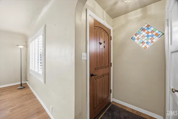 an entryway with a painting on the wall