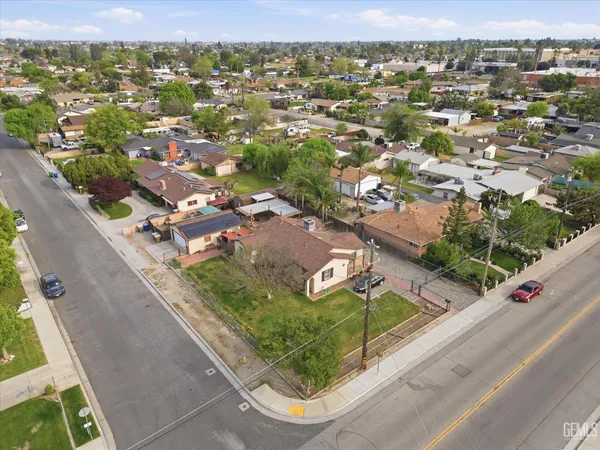 an aerial view of residential houses with city view