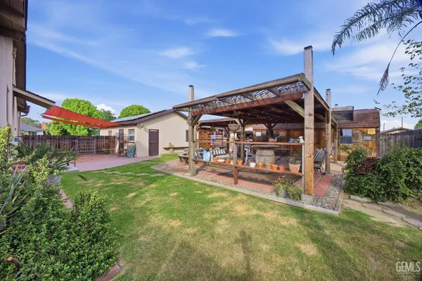 a view of a house with swimming pool and sitting area