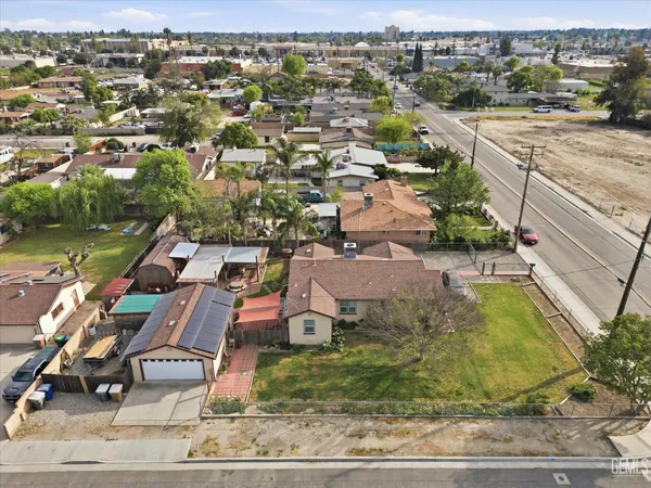 an aerial view of residential houses with outdoor space and parking