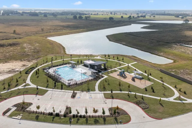 a view of a swimming pool with a yard