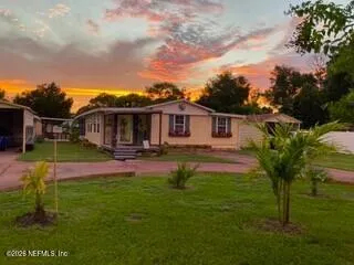 a view of house with swimming pool yard and green space