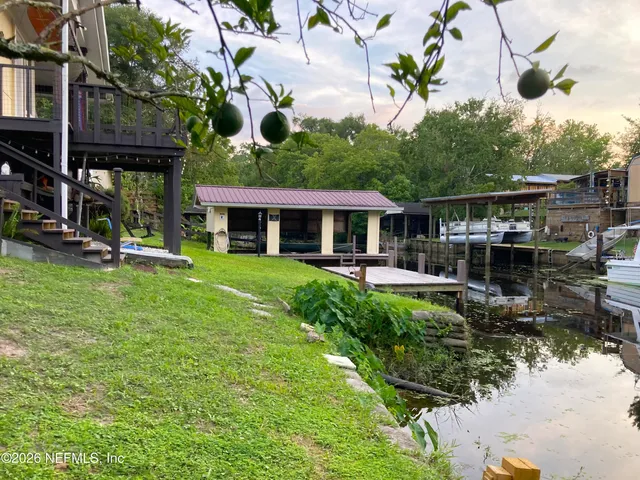 a kitchen with stainless steel appliances a refrigerator sink and white cabinets