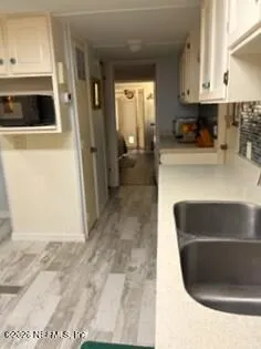 a kitchen with cabinets appliances and a sink