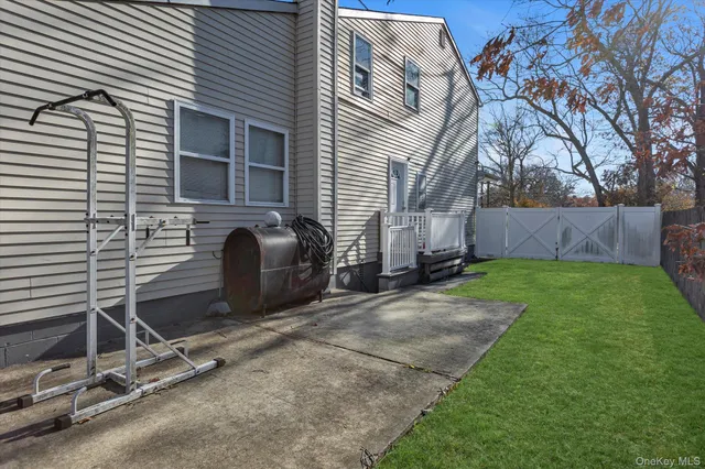 a view of backyard with wooden fence