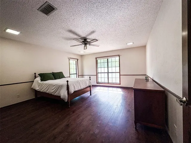 a spacious bedroom with a large bed and a window
