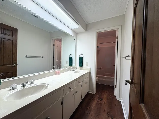a en suite bathroom with a double vanity sink a large mirror and shower