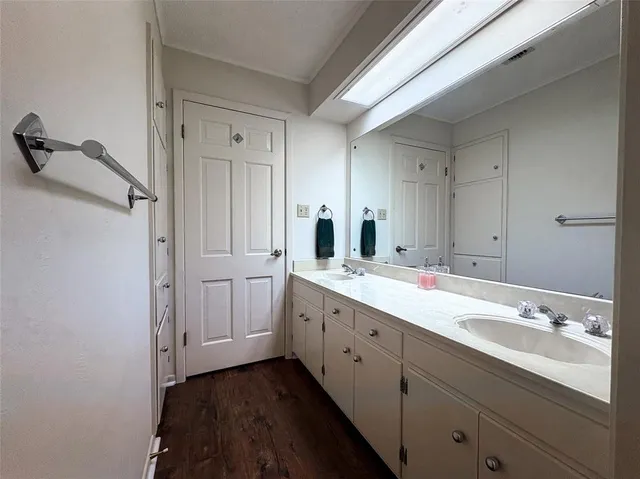 a bathroom with a double vanity sink and mirror