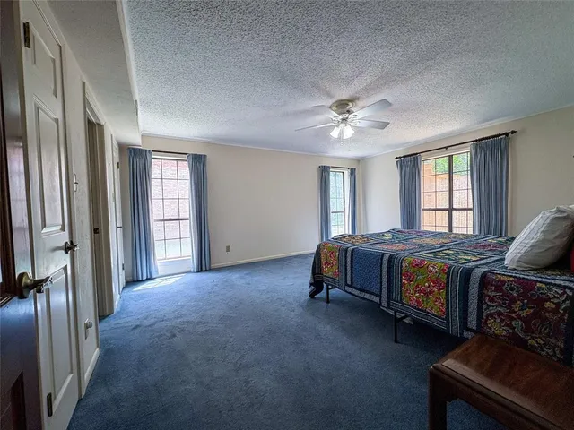 a spacious bedroom with a bed and window